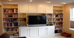 view of the wooden cabinet with books and television after interior renovation and renovation