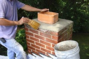 a painting expert is painting a drywall