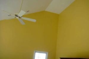 corner view of the house with ceiling fan after interior painting