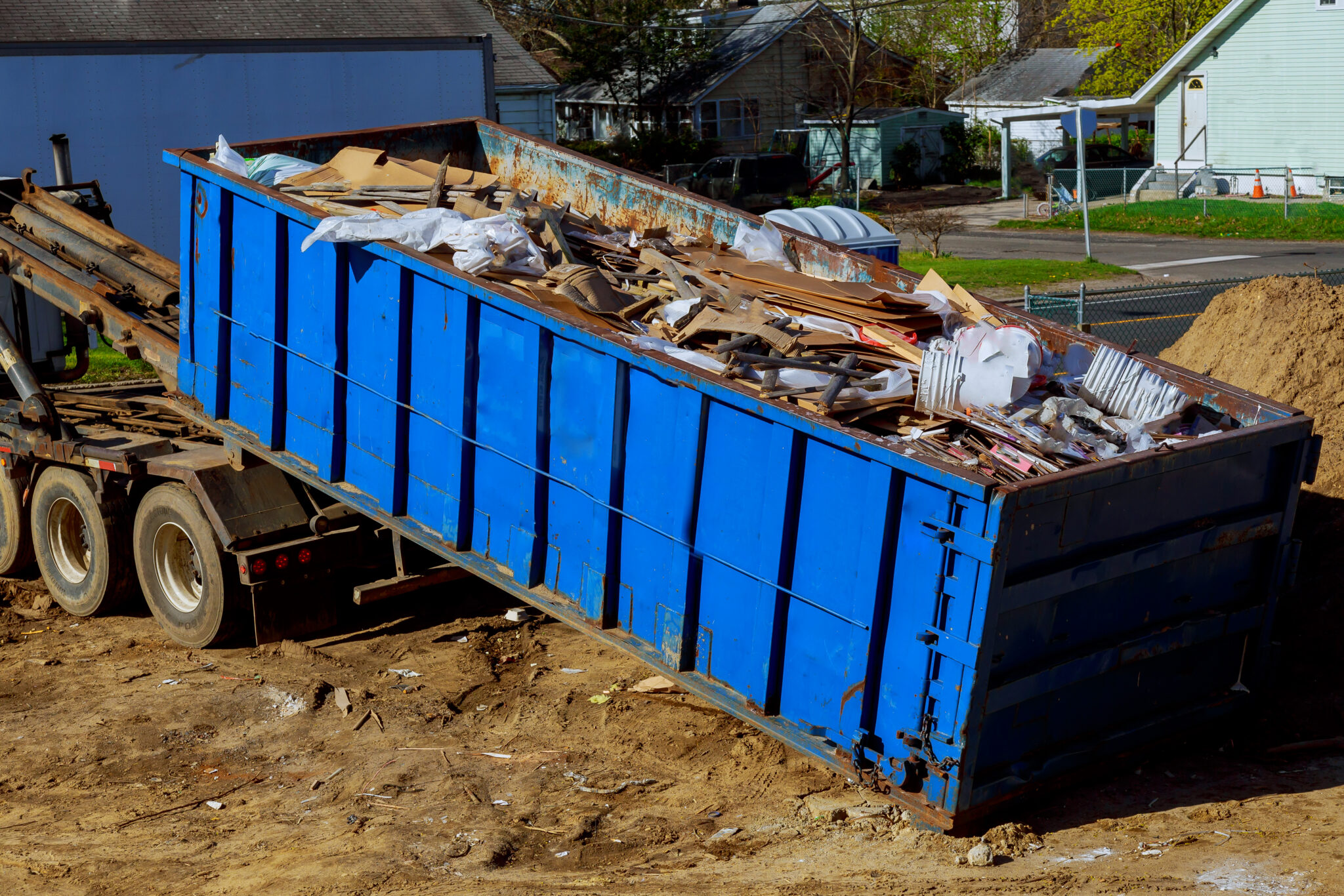 Truck loading a full skip recycling garbage waste management container