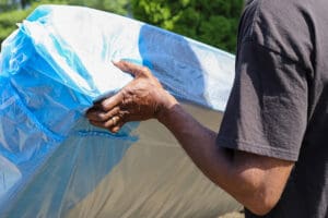 Man removing mattress from home