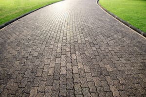 Old looking brick walkway surrounded by grass